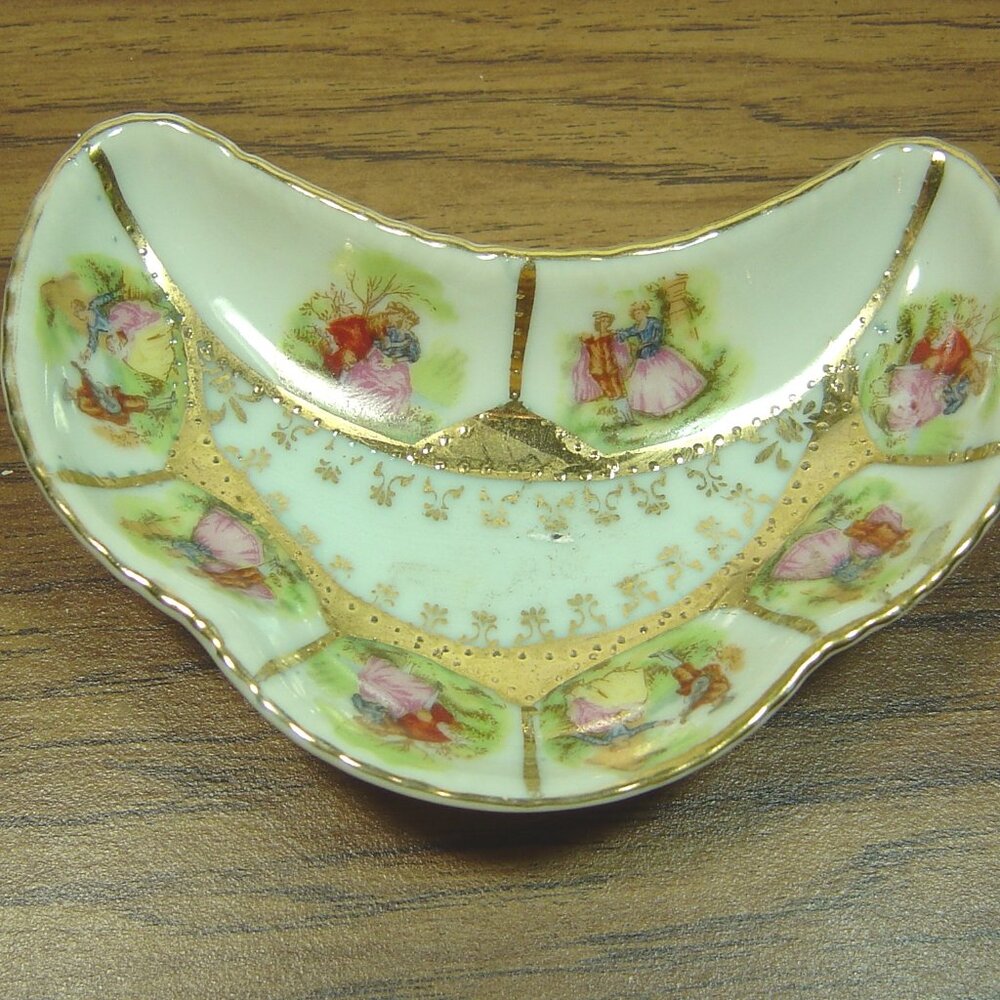 Vintage crescent shaped bone dish with Victorian man & lady scenes